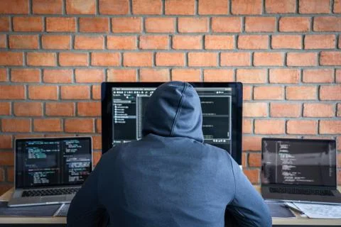 Computer hacker or cyber attack concept, Dangerous hooded hacker using multip 스톡 사진