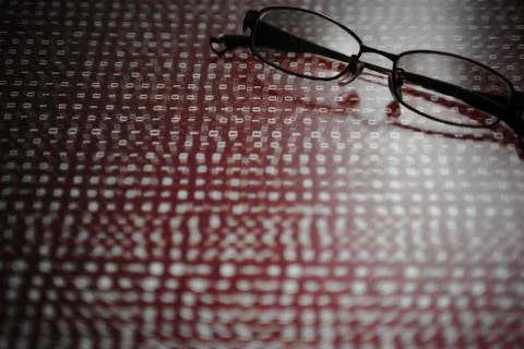 Computer hacker. red dangerous code breach into red binary code with glasses Stock Photos