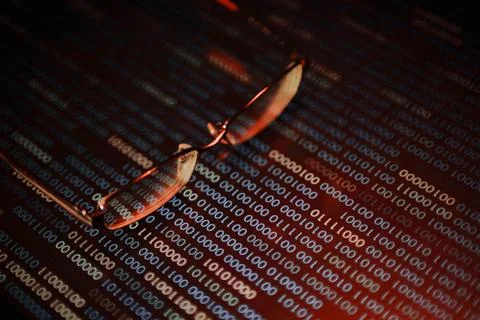 Computer hacker. red dangerous code breach into red binary code with glasses Stock Photos