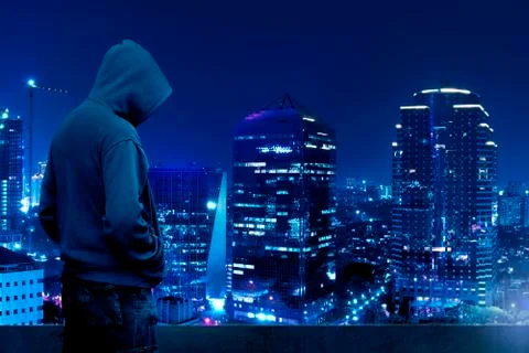 Computer hacker silhouette of hooded man Stock Photos
