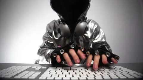 Computer hacker in silver jacket Stock Footage 144599706