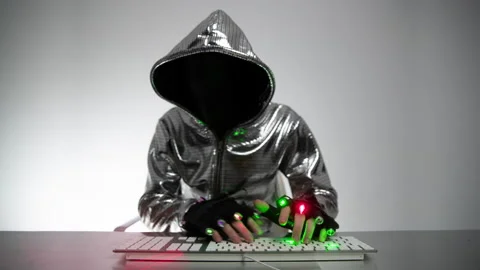 Computer hacker in silver jacket Stock Footage 144599892