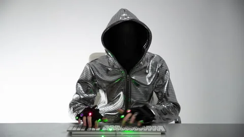 Computer hacker in silver jacket Stock Footage 144600065