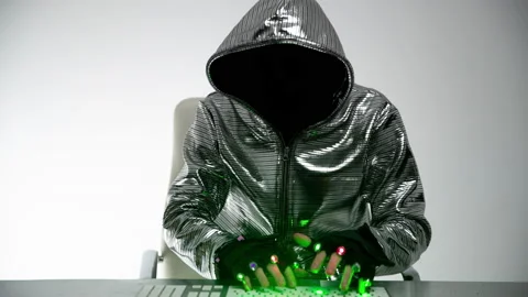 Computer hacker in silver jacket Stock Footage 144772036
