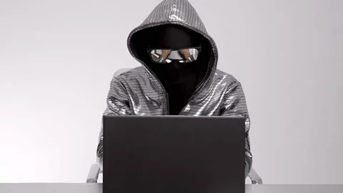 Computer hacker in silver jacket Stock Footage 144773434