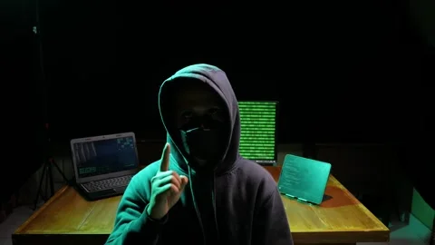 Computer Hacker Speaks into the Camera. In the Background His Operating Room Stock Footage 280178917