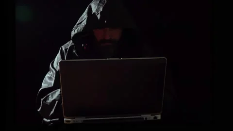 Computer hacker stealing data from a laptop Stock Footage 130798885