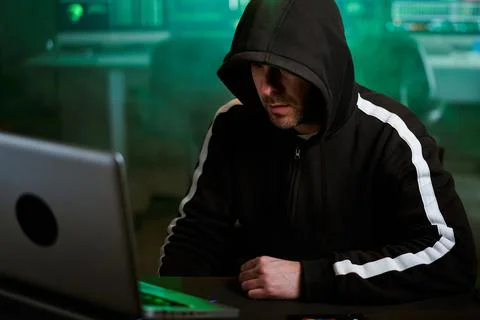 Computer hacker typing code on keyboard late night working and bypassing cyber Stock Photos