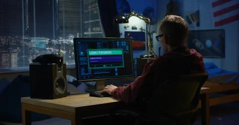 Computer hacker using his computer Stock Photos