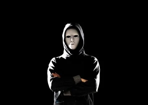 Computer hacker in white mask and hoodie. Obscured dark face. Data thief Foto stock