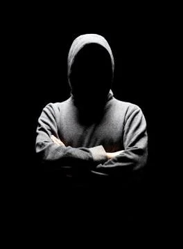 Computer hacker in white mask and hoodie. Obscured dark face. Data thief 스톡 사진