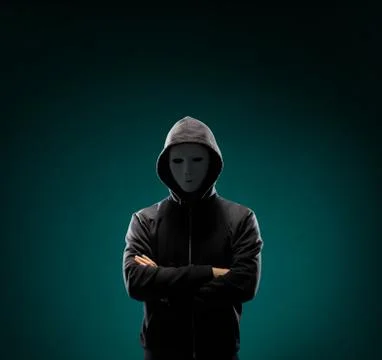Computer hacker in white mask and hoodie. Obscured dark face. Data thief Stock Photos