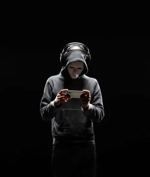 Computer hacker in white mask and hoodie. Obscured dark face. Data thief Stockfoto's