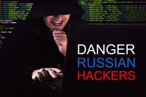 Computer hacker working in dark room Stock Photos