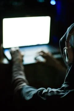Computer hacker working on laptop in the dark Stock Photos
