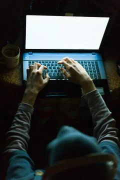 Computer hacker working on laptop in the dark Stock Photos