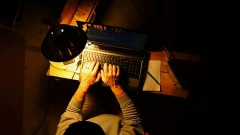 A computer hacker working remotely in dark room Stock Footage 81994112