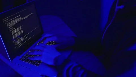 Computer hacker writing code on a laptop Stock-Footage 235726330