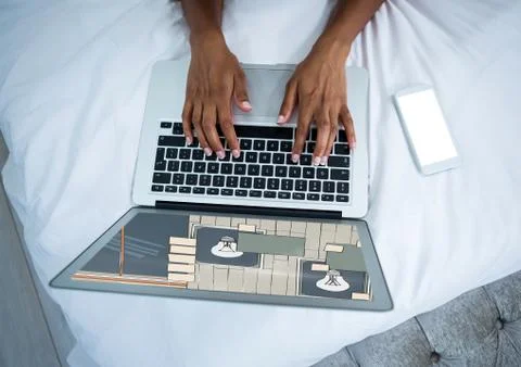 Computer with hands on bed. On the screen the design for the wall. Stock Photos