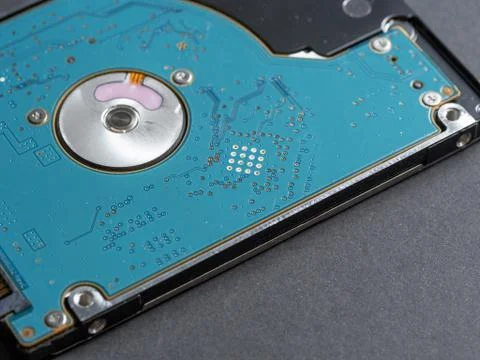 Computer hard disk bottom view close up on a dark paper background Stock Photos