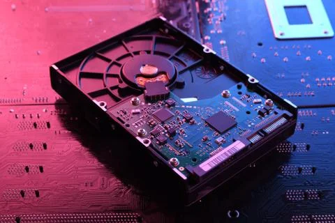 Computer Hard disk drives HDD , SSD on circuit board ,motherboard background. Stock Photos