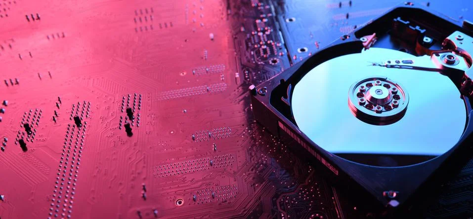 Computer Hard disk drives HDD , SSD on circuit board ,motherboard background. Stock Photos