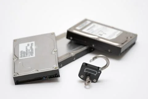 Computer hard disks and open metal padlock symbolizing concept for encrypted  Stock Photos