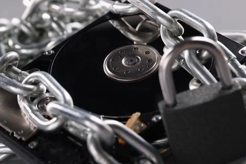 Computer hard drive with chain lock closeup Stock Photos