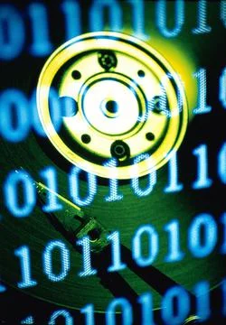 Computer hard drive superimposed over binary code 스톡 사진