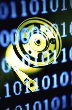 Computer hard drive superimposed over binary code Stock Photos