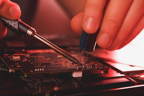 Computer hardware engineering. developer soldering electronic component Stock Photos