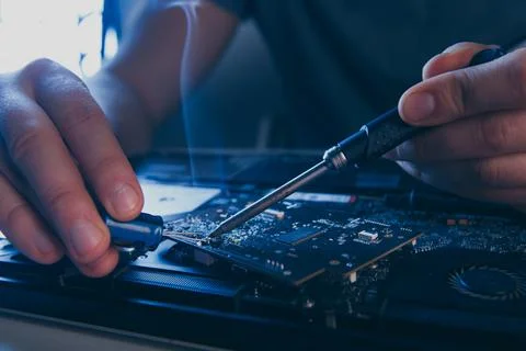 Computer hardware engineering. developer soldering electronic component Stock Photos