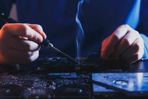 Computer hardware engineering. developer soldering electronic component Stock Photos
