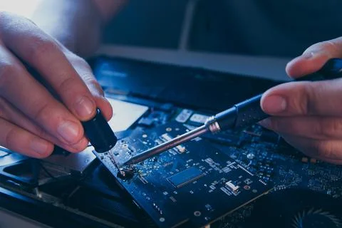 Computer hardware engineering. developer soldering electronic component Stock Photos