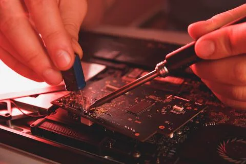 Computer hardware engineering. developer soldering electronic component Stock Photos