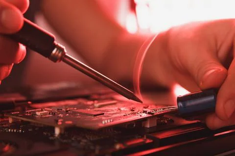 Computer hardware engineering. developer soldering electronic component Stock Photos