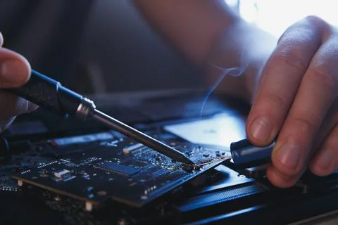 Computer hardware engineering. developer soldering electronic component Stock Photos
