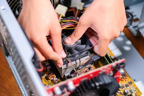 Computer hardware maintenance repairing a cpu fan a tech workshop Stock Photos