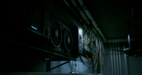 Computer hardware setup in a dimly lit server room with cooling fans Stock Footage 308805463