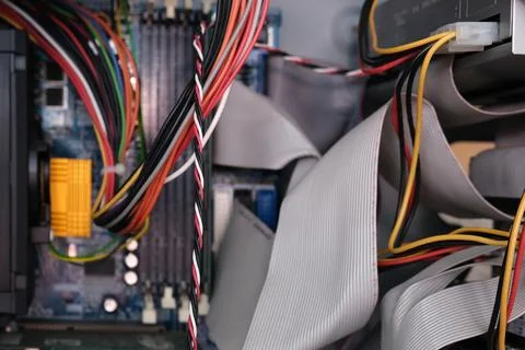 A computer that has many wires and cables coming out of it Stock Photos