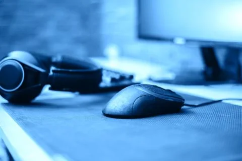 Computer headphones keyboard mouse on table on brick background at home Stock Photos