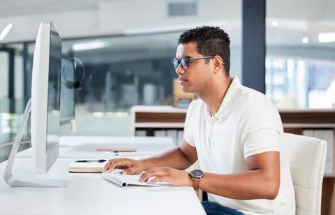 Computer, IT and man developer typing or coding in an office working on a 스톡 사진