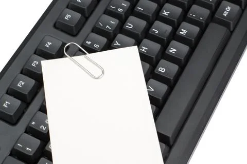 Computer keyboard and a clean sheet for notes memos. On a white background. Stock Photos