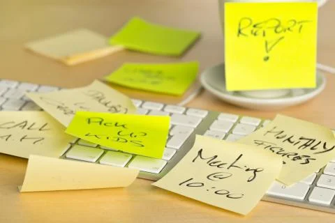 Computer keyboard and coffee cup covered with sticky notes with different app Stock Photos