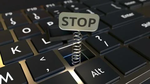 Computer keyboard and jack-in-the-box STOP message in the key. Conceptual 3D Illustrazione stock