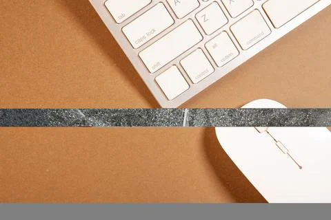 Computer keyboard and mouse on brown background. Top view with copy space Stock Photos