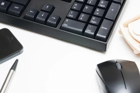 Computer keyboard and mouse, pen, wooden car, phone isolated on white backgro Stock Photos