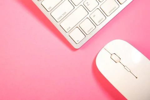Computer keyboard and mouse on pink background. Top view with copy space 스톡 사진