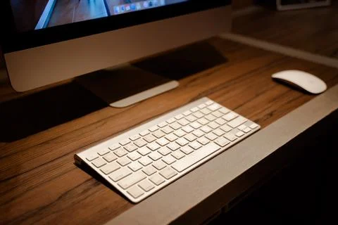 Computer keyboard and mouse placed on wooden table ready to use Stock Photos