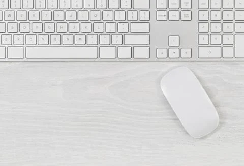 Computer keyboard and mouse on top of white desktop Stock Photos